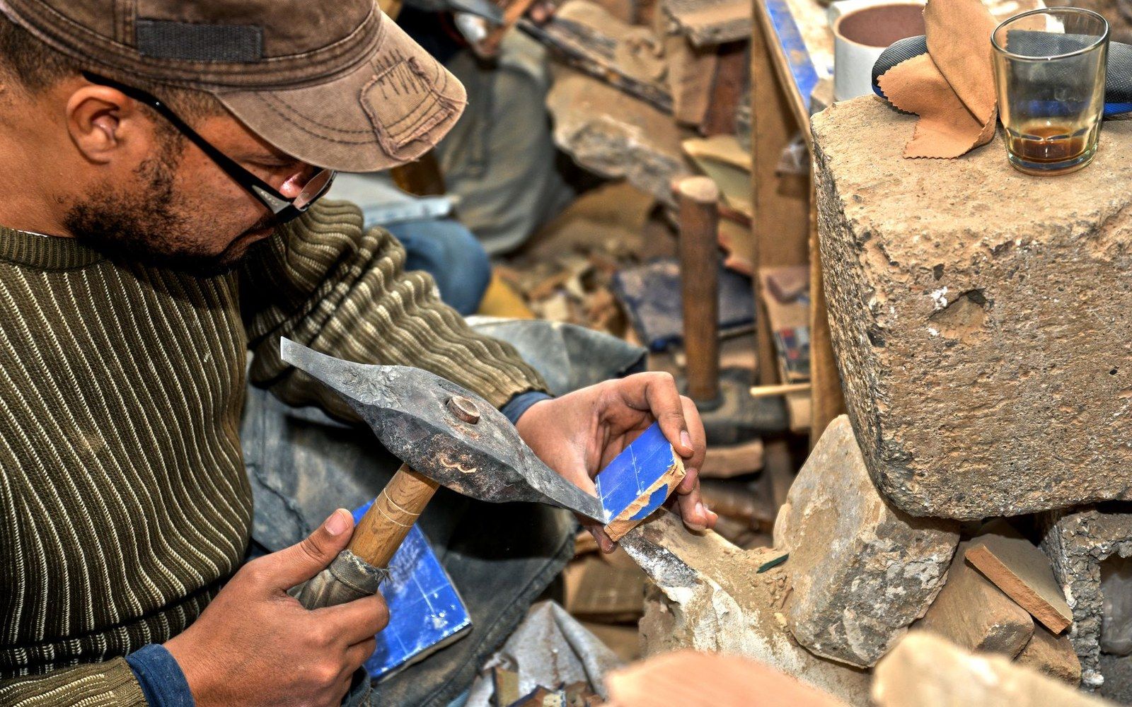 A tilesetter cutting a piece to fit a geometric field